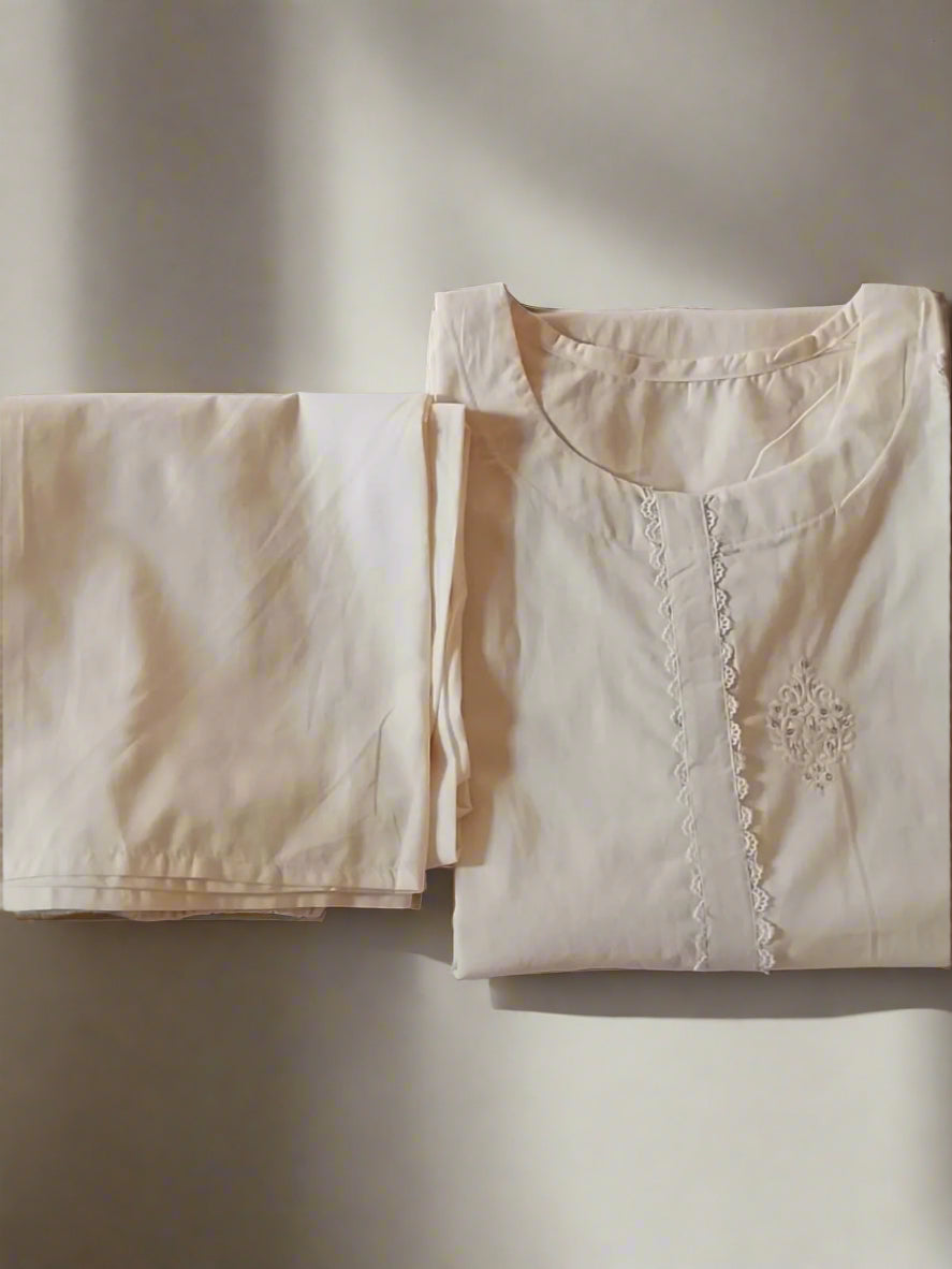 Beige shirt with lace details on a textured surface